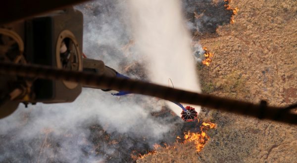 epa10793801 A handout photo made available by the US Army National Guard on 10 August 2023 shows a Hawaii Army National Guard CH47 Chinook dropping water on a burning wildfire on the Island of Maui, Hawaii, USA, 09 August 2023 (issued 10 August 2023). The White House on 10 August declared the ongoing Hawaii wildfires a major disaster, after hundreds of buildings on the island were destroyed, thousands of people were evacuated and at least 36 people lost their lives.  EPA/MASTER SGT ANDREW JACKSON / US ARMY NATIONAL GUARD HANDOUT NO SALES, EDITORIAL USE ONLY HANDOUT EDITORIAL USE ONLY/NO SALES
