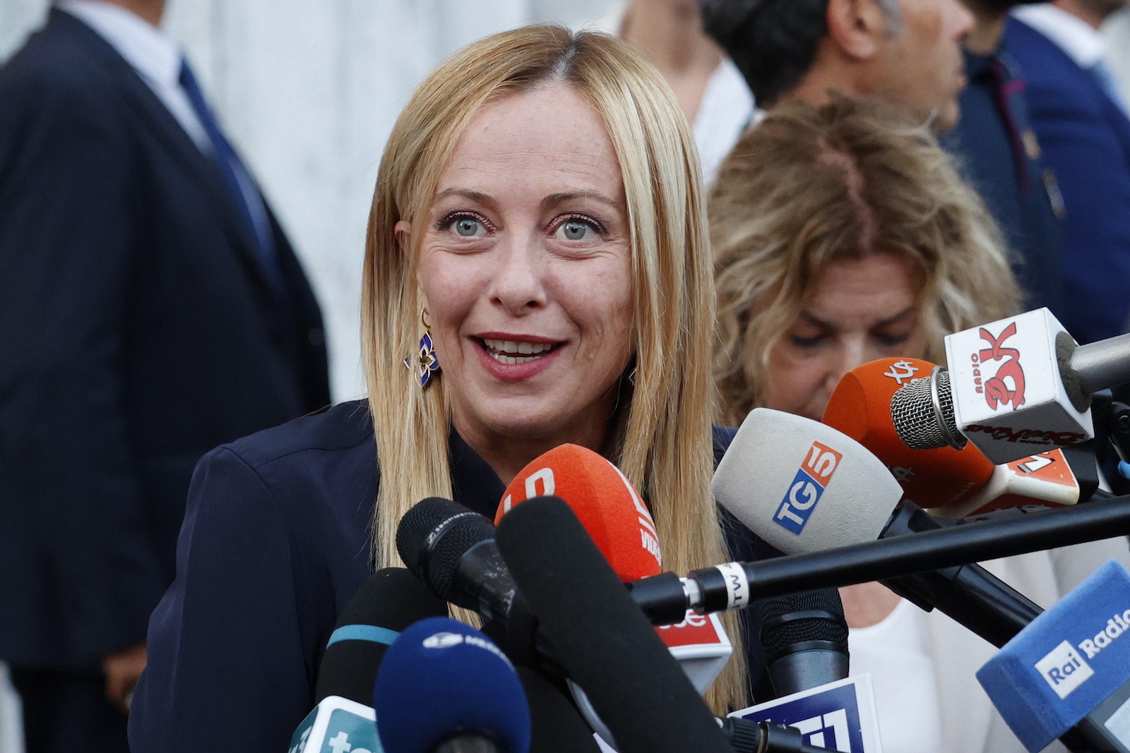 epa10795606 Italian Prime Minister Giorgia Meloni talks with journalists at the end of a meeting with the opposition, at Palazzo Chigi in Rome, Italy, 11 August 2023. Meloni met the opposition parties that presented a bill to introduce a minimum wage of nine euros per hour in Italy.  EPA/FABIO FRUSTACI
