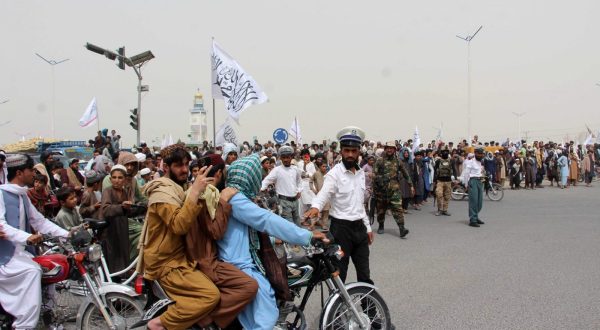 epa10801336 Afghans hold flags of Islamic Emirate of Afghanistan, as they celebrate second anniversary of Taliban taking over the government, in Kandahar, Afghanistan, 15 August 2023. The Taliban's ascent to power on 15 August 2021 has led to the extremist interpretation of Shariah or Islamic law, resulting in a complete reversal of the women's rights ensured in recent years. Meanwhile, the takeover has led to the country being isolated internationally, after the international community turned back on the new Taliban government and imposed sanctions whose burden is being borne by common Afghans.  EPA/STR