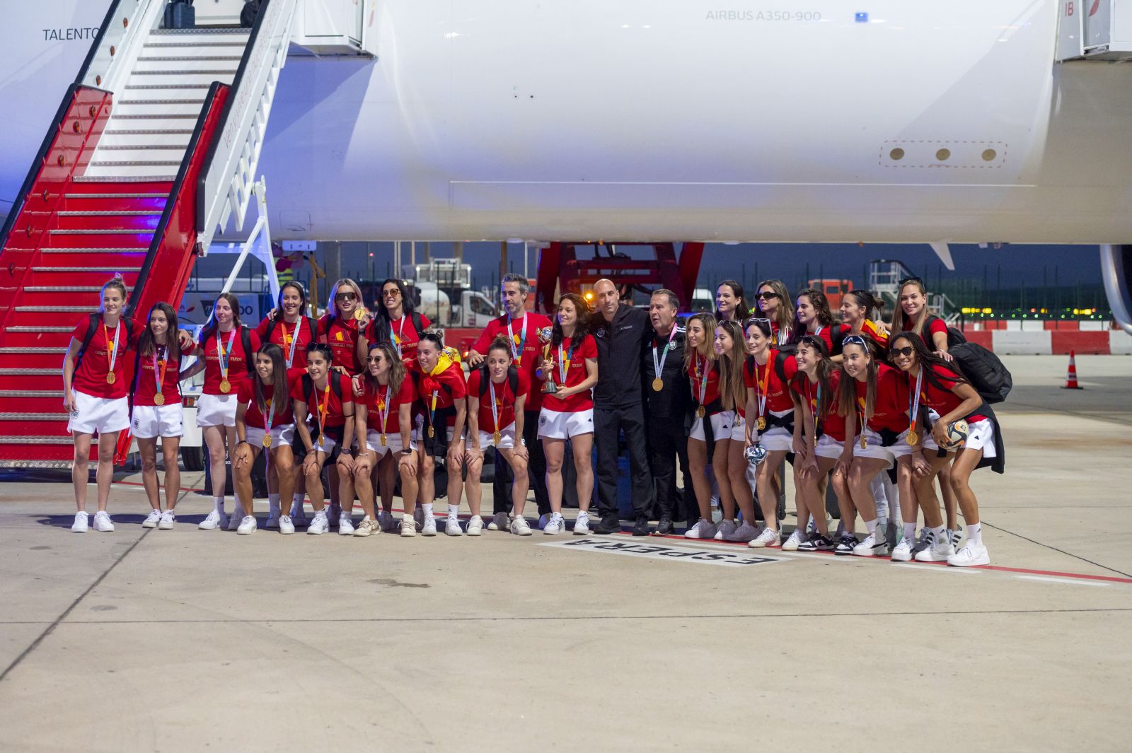epa10812630 Spain's players, head coach Jorge Vilda (7-L) and president of Spanish Royal Soccer Federation Luis Rubiales (7-R) react upon arrival following their victory in the FIFA Women's World Cup 2023, in Puente del Rey, Madrid, Spain, 21 August 2023. Spain defeated England on the FIFA Women's World Cup 2023 Final soccer match at Stadium Australia in Sydney, Australia, on 20 August 2023.  EPA/FERNANDO VILLAR