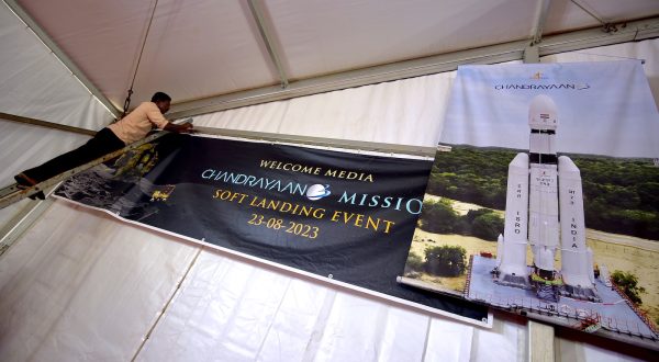 epa10815351 Indian labourers hang a poster during the soft landing of the 'Chandrayaan-3 Mission' event at ISRO Telemetry, Tracking and Command Network (ISTRAC) in Bangalore, India, 23 August 2023. Indian Space Research Organisation (ISRO) space exploration Chandrayaan-3 Mission is expected to land on the moon on 23 August at approximately 18:04 (IST).  EPA/JAGADEESH NV