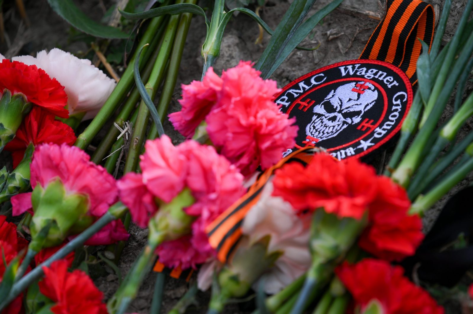 epaselect epa10817441 Flowers and a patch with the logo of PMC Wagner laid at an informal memorial next to the former 'PMC Wagner Centre' in St. Petersburg, Russia, 24 August 2023. An investigation was launched into the crash of an aircraft in the Tver region in Russia on 23 August 2023, the Russian Federal Air Transport Agency said in a statement. Among the passengers was Wagner chief Yevgeny Prigozhin, the agency reported.  EPA/ANTON MATROSOV