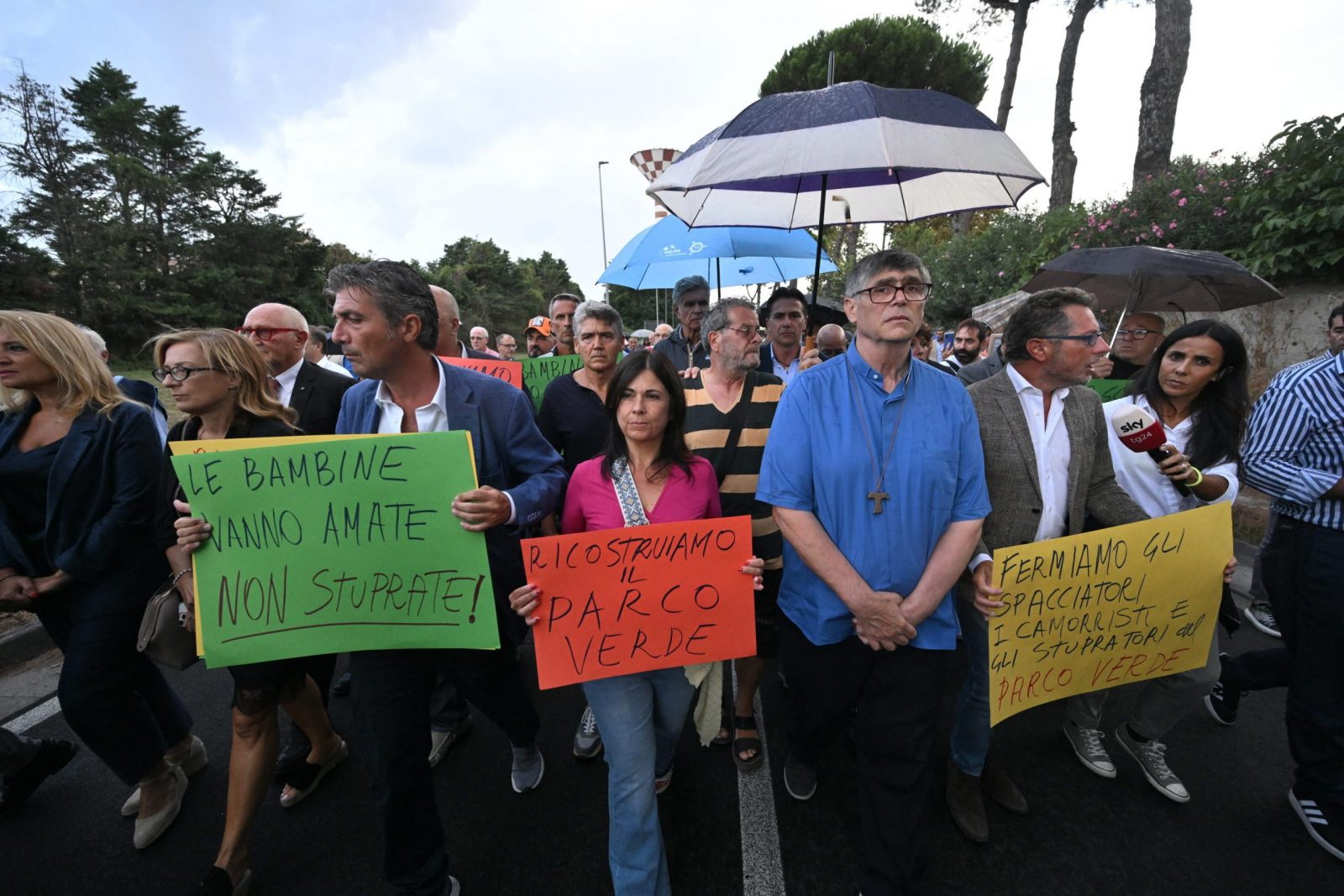 epa10827217 The parish priest Maurizio Patriciello (5-R) attends the procession, against the degradation of the neighborhood, in front of the church of San Paolo Apostolo, in Caivano, near Naples, Italy, 29 August 2023. The Italian Prime Minister Meloni told cabinet 29 August that the crime and drug ridden town of Caivano near Naples would be 'cleaned up' by Italian authorities, after two 13-year-old cosuins were allegedly gang raped last month.  EPA/CIRO FUSCO