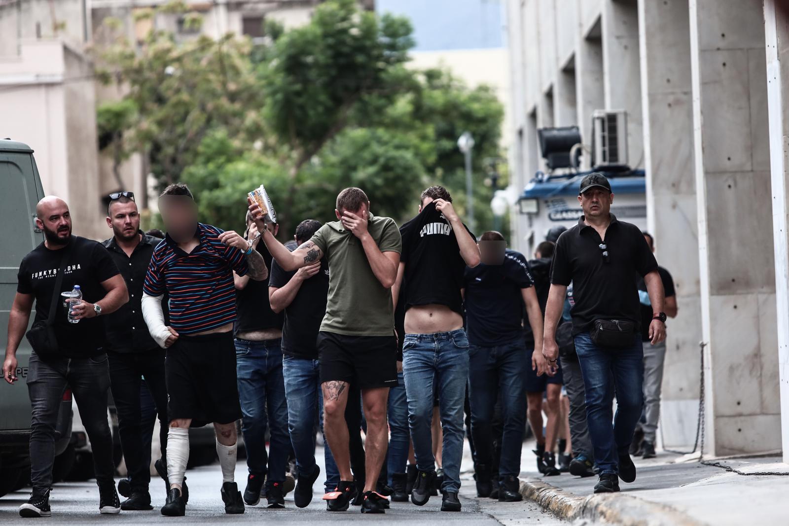 13.08.2023., Atena, Grcka - Poslejdnja skupina privedenih navijaca izlazi pred skudskog istrazitelja izjasniti se o optzbama koje im se stavljau na teret. Inace, svi do sada navijacima koji su izvedeni pred istrazitelja produzen je pritvor. Photo: KOSTAS TZOUMAS/EUROKINISSI/PIXSELL