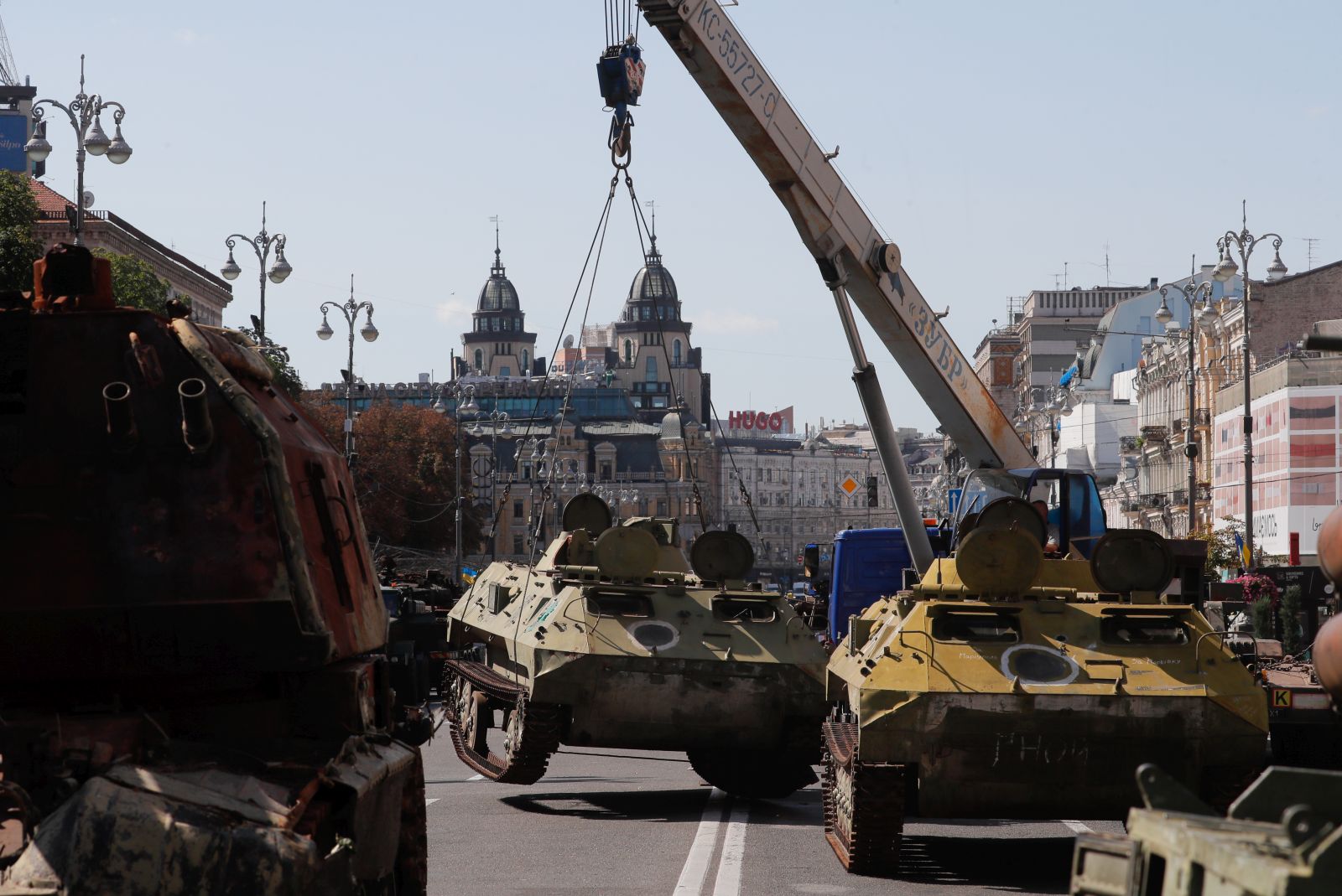 epa10813290 Army and municipal workers set up damaged Russian armored military vehicles that were seized by the Ukrainian army amid the Russian invasion, along Khreshchatyk Street in Kyiv (Kiev), Ukraine, 22 August 2023. The damaged Russian military machinery was set up in downtown Kyiv prior to the upcoming Independence Day celebrations on 24 August.  EPA/SERGEY DOLZHENKO