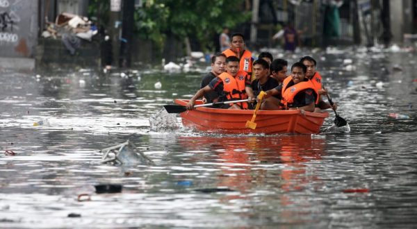 epa10830344 An emergency response team uses a raft to help transport residents along a flooded road in Quezon City, Metro Manila, Philippines, 31 August 2023. Typhoon Saola, which has left the Philippine Area of Responsibility, and Tropical Storm Haikui off the coast of extreme northern provinces are enhancing a southwest monsoon bringing rains in the western Luzon region of the country, according to data from the Philippine Atmospheric Geophysical and Astronomical Services Administration (PAGASA). Figures from the National Disaster Risk Reduction and Management Council (NDRRMC) show that over 305,000 individuals were affected by the passing of Typhoon Saola.  EPA/ROLEX DELA PENA