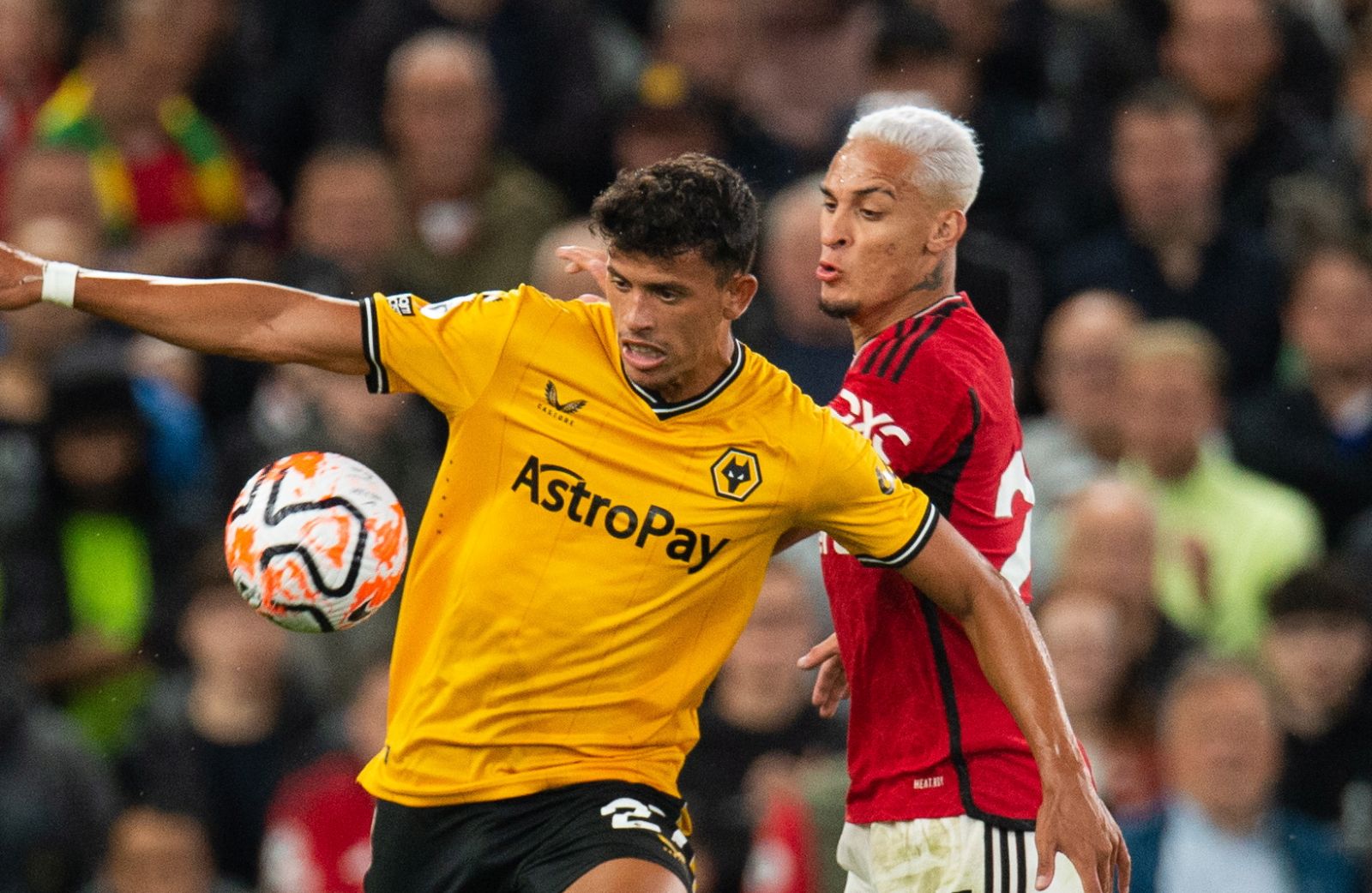 epa10800509 Wolverhampton Wanderers Matheus Nunes (L) in action with Manchester United's Antony (R) during the English Premier League match between Manchester United and Wolverhampton Wanderers in Manchester, Britain, 14 August 2023.  EPA/PETER POWELL EDITORIAL USE ONLY. No use with unauthorized audio, video, data, fixture lists, club/league logos or 'live' services. Online in-match use limited to 120 images, no video emulation. No use in betting, games or single club/league/player publications
