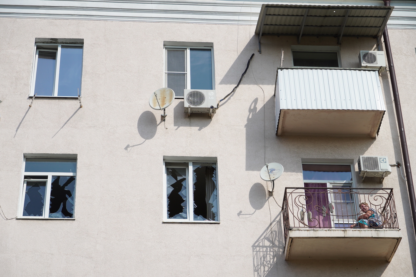 epa10845629 A local woman sits on the balcony of her damaged apartment following a drone attack in downtown Rostov-on-Don, Russia, 07 September 2023. Russian Air defense systems shot down one drone on approach to Rostov-on-Don, and the second in the city center, said the governor of the Golubev region. On Pushkinskaya Street, the facades of several buildings were damaged, the windows of three buildings were shattered, and several cars were damaged. Traffic in the area of the incident was limited. As a result of damage to an electrical panel in the area of the incident, 20 houses remain without electricity.  EPA/STRINGER
