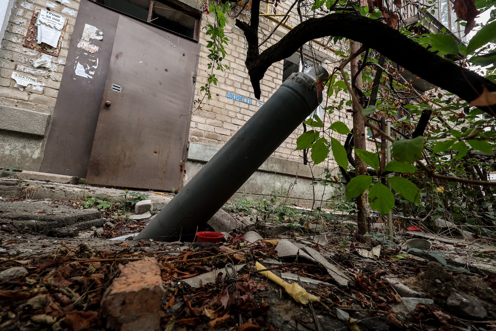 epa10846750 Part of a missile next to a destroyed apartment block in the frontline town of Orikhiv, Zaporizhzhia Oblast, Ukraine, 07 September 2023, amid the Russian invasion. The town, located less than 10 kilometers from the nearest Russian army position, witnesses daily attacks from Russian forces. Its school was operating as a center for distribution of humanitarian aid until the premises were hit by two consecutive air strikes. Airstrike survivor Lubov Jarova says that her dog saved her life. Following the first strike, she ran after it outside the school when the second strike happened, destroying the building and killing seven people. Today Lubov lives in Zaporizhzhia, around 65 kilometers north-west, and she occasionally brings humanitarian aid to her hometown. Before the war, Orikhiv had a population of over 14,000. The town is currently home to around 700 people.  EPA/KATERYNA KLOCHKO  ATTENTION: This Image is part of a PHOTO SET