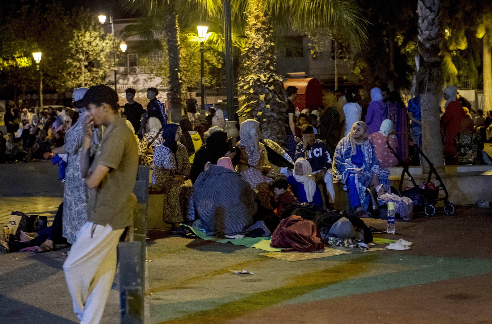 epa10849885 People seek safety outside after an earthquake in Rabat, Morocco, 08 September 2023. A 6.8-magnitude earthquake struck Morocco late 08 September, damaging buildings in major cities and sending panicked people pouring into streets and alleys. According to Morocco's state-run media, at least 296 people died in the earthquake in the provinces and prefectures of Al Haouz, Marrakech, Ouarzazate, Azilal, Chichaoua and Taroudant, and 153 people were injured.  EPA/Jalal Morchidi