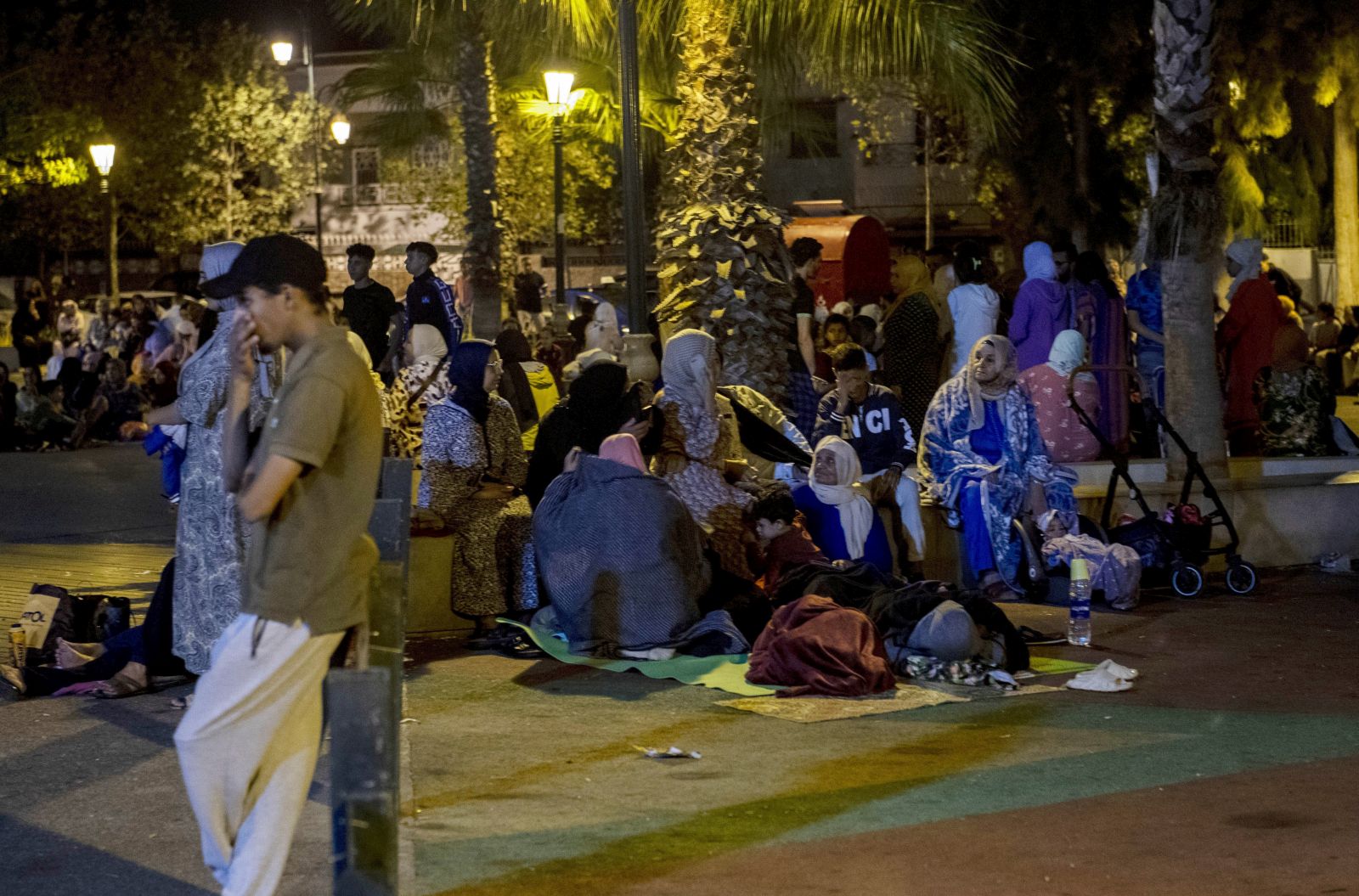 epa10849885 People seek safety outside after an earthquake in Rabat, Morocco, 08 September 2023. A 6.8-magnitude earthquake struck Morocco late 08 September, damaging buildings in major cities and sending panicked people pouring into streets and alleys. According to Morocco's state-run media, at least 296 people died in the earthquake in the provinces and prefectures of Al Haouz, Marrakech, Ouarzazate, Azilal, Chichaoua and Taroudant, and 153 people were injured.  EPA/Jalal Morchidi