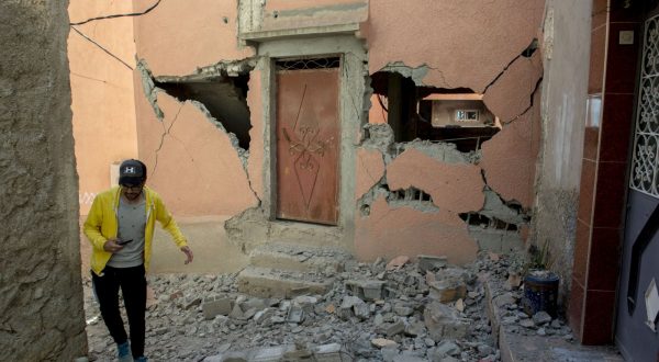 epa10850165 A person walks over debris next to a damaged building following an earthquake in Marrakesh, Morocco, 09 September 2023. A powerful earthquake that hit central Morocco late 08 September, killed at least 820 people and injured 672 others, according to a provisional report from the country's Interior Ministry. The earthquake, measuring magnitude 6.8 according to the USGS, damaged buildings from villages and towns in the Atlas Mountains to Marrakesh.  EPA/JALAL MORCHIDI