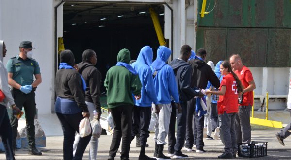 epa10854677 Red Cross members take care of migrants before they are transferred to Tenerife on board a ferry of Spanish ferry services company 'Naviera Armas' from Valverde's port in El Hierro island, Canary Islands, Spain, 11 September 2023. A total of 313 migrants will be transfered to Tenerife after reaching the Spanish coasts on board of small boats.  EPA/GELMERT FINOL