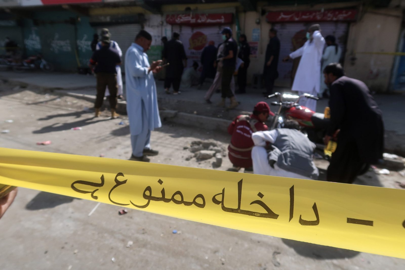 epa10855556 A view shows a cordoned off area where police officers inspect the scene of an explosion near a police vehicle in Quetta, the provincial capital of restive Balochistan province, Pakistan, 12 September 2023. According to The Station House Officer (SHO) of the Sariab Police Station, two people were injured in a roadside improvised explosive device (IED) attack on the morning of 12 September. Balochistan province has been experiencing a low-level insurgency for some time by organizations demanding greater autonomy.  EPA/FAYYAZ AHMED