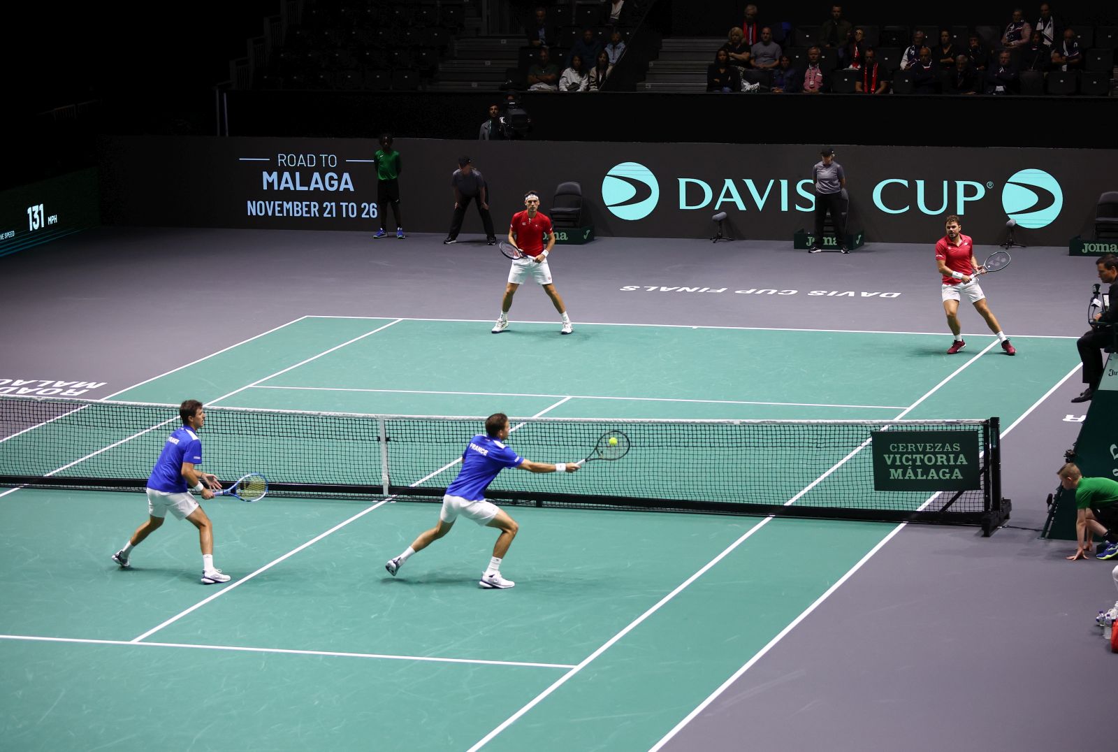 epa10856708 Nicolas Mahut and Edouard Roger-Vasselin of France in action against Marc-Andrea Huesler and Stan Wawrinka of Switzerland during the Davis Cup Finals Group B match between France and Switzerland at the AO Arena in Manchester, Britain, 12 September 2023.  EPA/ADAM VAUGHAN