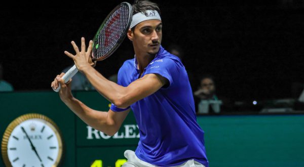 epa10858832 Lorenzo Sonego of Italy in action against Alexis Galarneau of Canada (not pictured) during the Davis Cup 2023 Group A match between Italy and Canada, in Bologna, Italy, 13 September 2023.  EPA/FABIO PATAMIA
