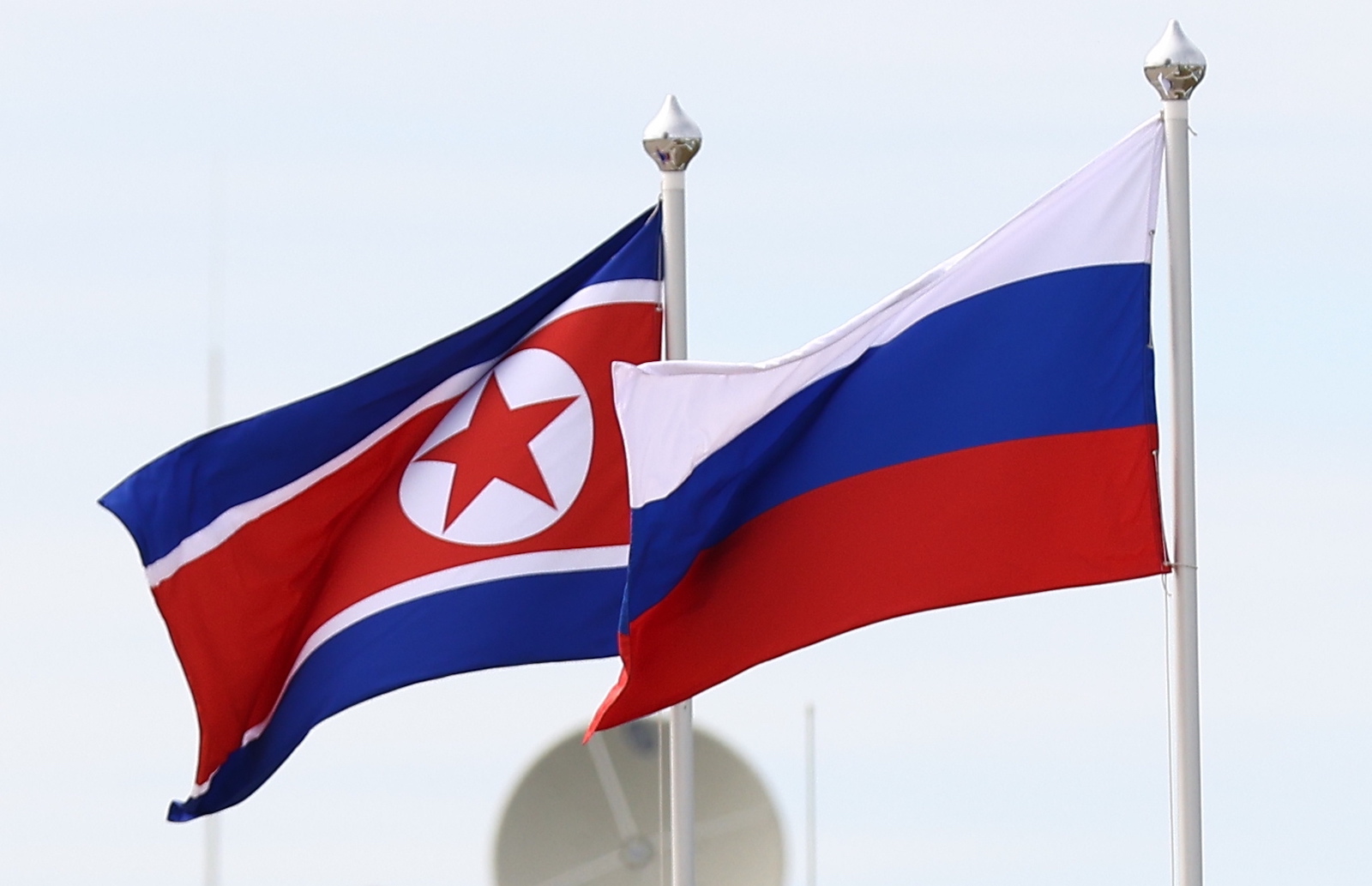 epa10859178 Flags of North Korea (L) and Russia fly during a visit of Russian President Putin and North Korean leader Kim Jong Un to the Vostochny cosmodrome, outside the town of Tsiolkovsky (former Uglegorsk), some 180km north of Blagoveschensk in Amur region, Russia, 13 September 2023.  EPA/ARTEM GEODAKYAN/SPUTNIK/KREMLIN / POOL MANDATORY CREDIT