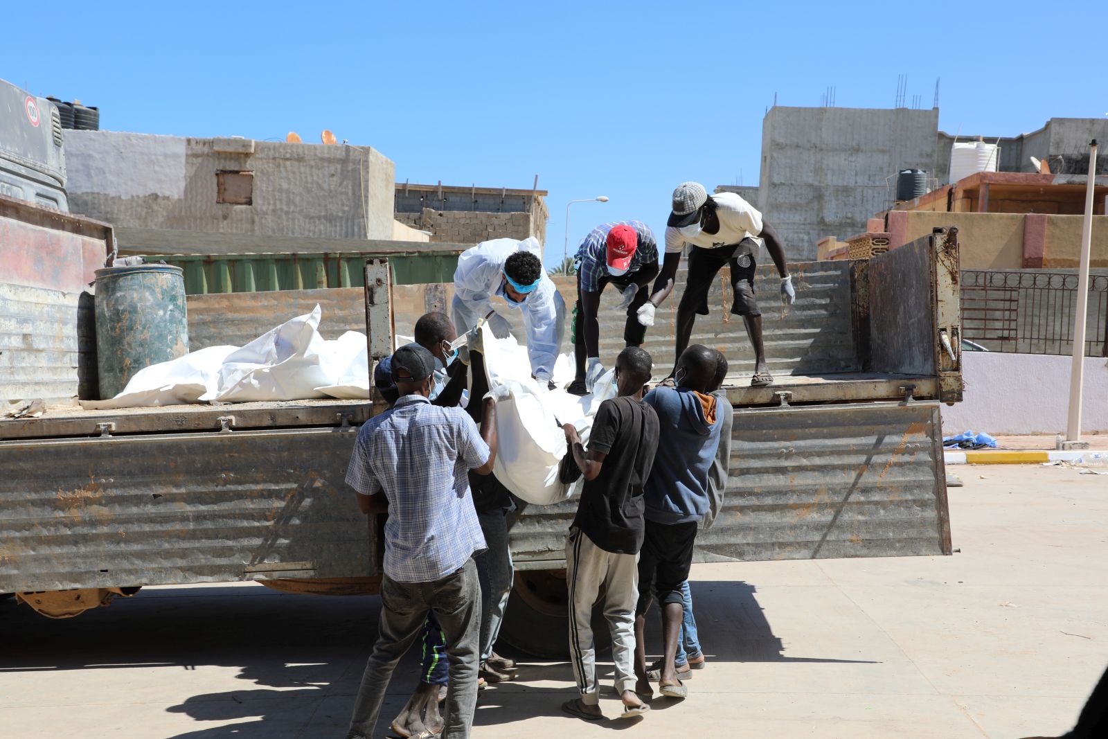 epa10859581 Rescue workers transport body bags with the remains of victims of the floods, which washed up ashore from the sea, outside the hospital of Derna, Eastern Libya, 13 September 2023, after Storm Daniel brought heavy rains to the area resulting in the collapse of two dams and a flash flood which especially devastated the town of Derna. The Libyan Red Cresent reported that the floods caused by storm Daniel on 10 September in eastern Libya left thousands of people dead and according to preliminary statistics, the number of missing people has exceeded ten thousand people.  EPA/Mohamed Shalash