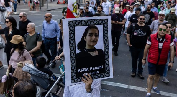 epa10863608 Protesters hold placards and flags during a rally marking the one-year anniversary of Mahsa Amini's death in custody, along Swanston Street, in Melbourne, Australia, 16 September 2023. Australian-Iranians are speaking out and protesting against the Iranian regime on the anniversary of Mahsa Amini's death, which led to nationwide protests over the country's mandatory dress code (Hijab) law. Protests erupted after the death of 22-year-old Iranian woman, Mahsa Amini, detained by morality police for not wearing the hijab properly in September 2022.  EPA/DIEGO FEDELE AUSTRALIA AND NEW ZEALAND OUT