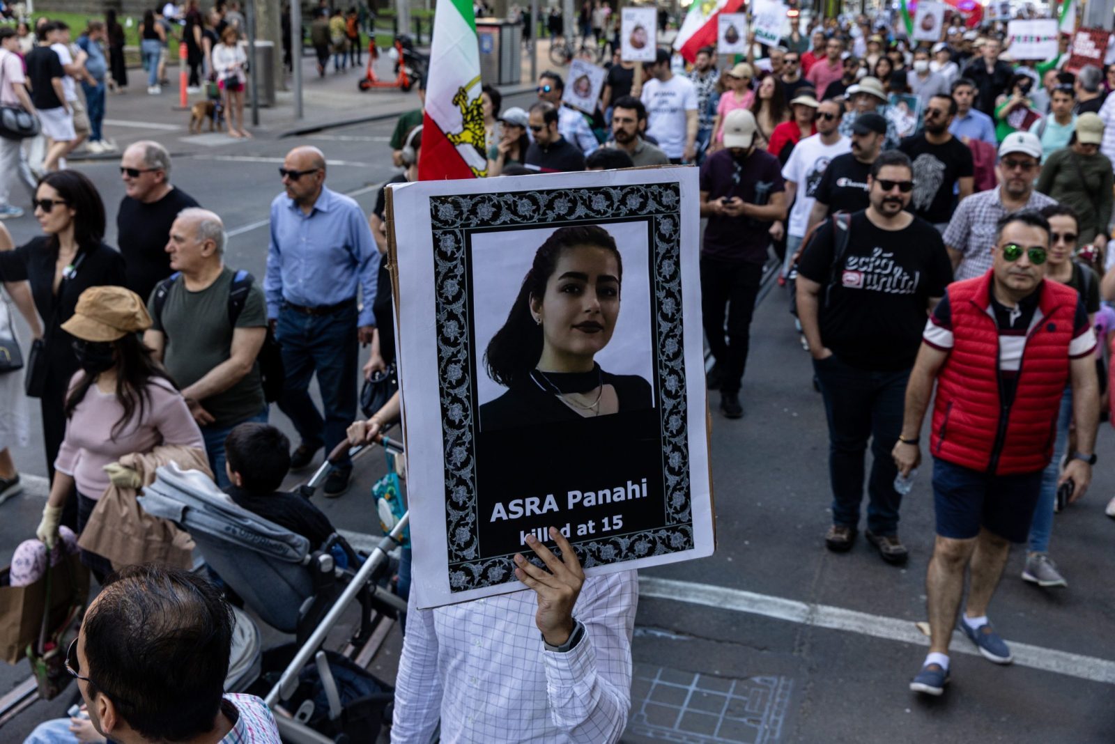 epa10863608 Protesters hold placards and flags during a rally marking the one-year anniversary of Mahsa Amini's death in custody, along Swanston Street, in Melbourne, Australia, 16 September 2023. Australian-Iranians are speaking out and protesting against the Iranian regime on the anniversary of Mahsa Amini's death, which led to nationwide protests over the country's mandatory dress code (Hijab) law. Protests erupted after the death of 22-year-old Iranian woman, Mahsa Amini, detained by morality police for not wearing the hijab properly in September 2022.  EPA/DIEGO FEDELE AUSTRALIA AND NEW ZEALAND OUT