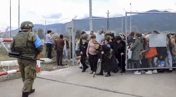 epa10873895 A still image taken from a handout video provided by the Russian Defence Ministry press-service shows civilians entering a Russian peacekeepers' camp near Stepanakert, Nagorno-Karabakh, 21 September 2023. About 5,000 people have been brought to the location of the Russian peacekeeping contingent as Russian peacekeepers have evacuated civilians from Martakert, Martuni, and Askeran districts of Nagorno-Karabakh, the Russian Defence Ministry announced on 21 September. Azerbaijan government's announced that a ceasefire was agreed with Armenian separatists in Nagorno-Karabakh on 20 September, after a 24-hour military offensive to take control of the enclave.  EPA/RUSSIAN DEFENCE MINISTRY PRESS SERVICE HANDOUT -- MANDATORY CREDIT -- BEST QUALITY AVAILABLE -- HANDOUT EDITORIAL USE ONLY/NO SALES