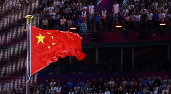 epa10878387 People attend the flag raising ceremony during the opening ceremony of the 19th Asian Games Hangzhou 2022 at the Olympic Sports Centre Stadium in Hangzhou, China, 23 September 2023. The 2022 Asian Games were postponed due to the Covid-19 pandemic and are held between 23 September and 08 October 2023.  EPA/ALEX PLAVEVSKI