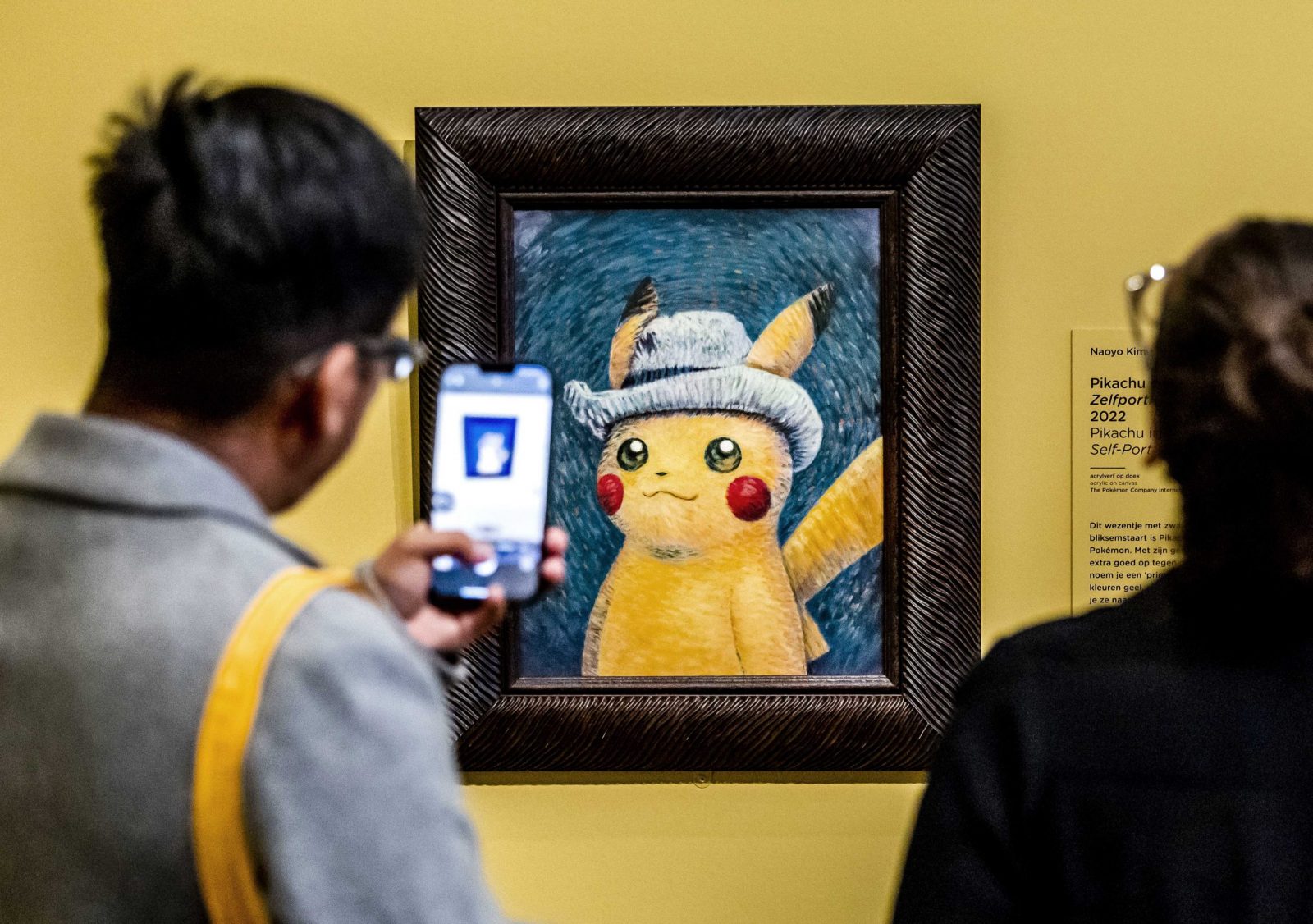 epaselect epa10888485 Visitors look at a painting by an artist who was inspired by Vincent van Gogh's work, at the Van Gogh Museum in Amsterdam, the Netherlands, 28 September 2023. Some of Vincent van Gogh's best-known works inspired six paintings that artists from The Pokemon Company have created of Pokemon. The exhibition runs from 28 September to 07 January 2024.  EPA/REMKO DE WAAL