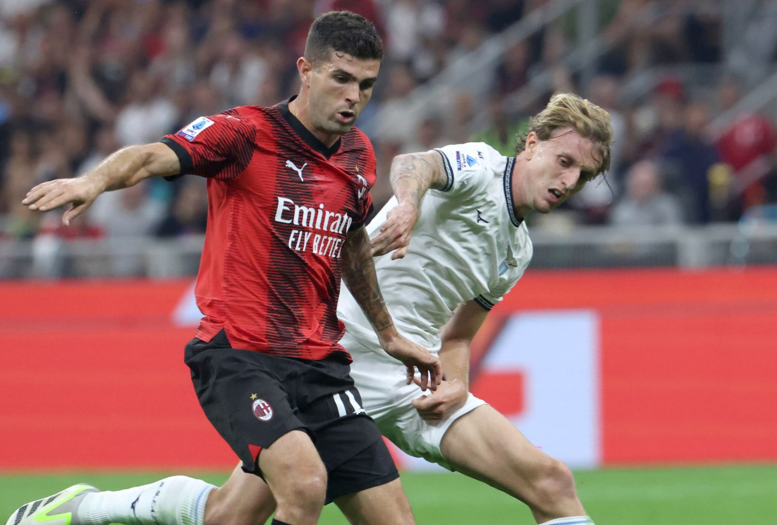 epa10892607 AC Milan’s Christian Pulisic (L) and Lazio’s Nicolo Rovella in action during the Italian Serie A soccer match between AC Milan and SS Lazio in Milan, 30 September 2023.  EPA/MATTEO BAZZI