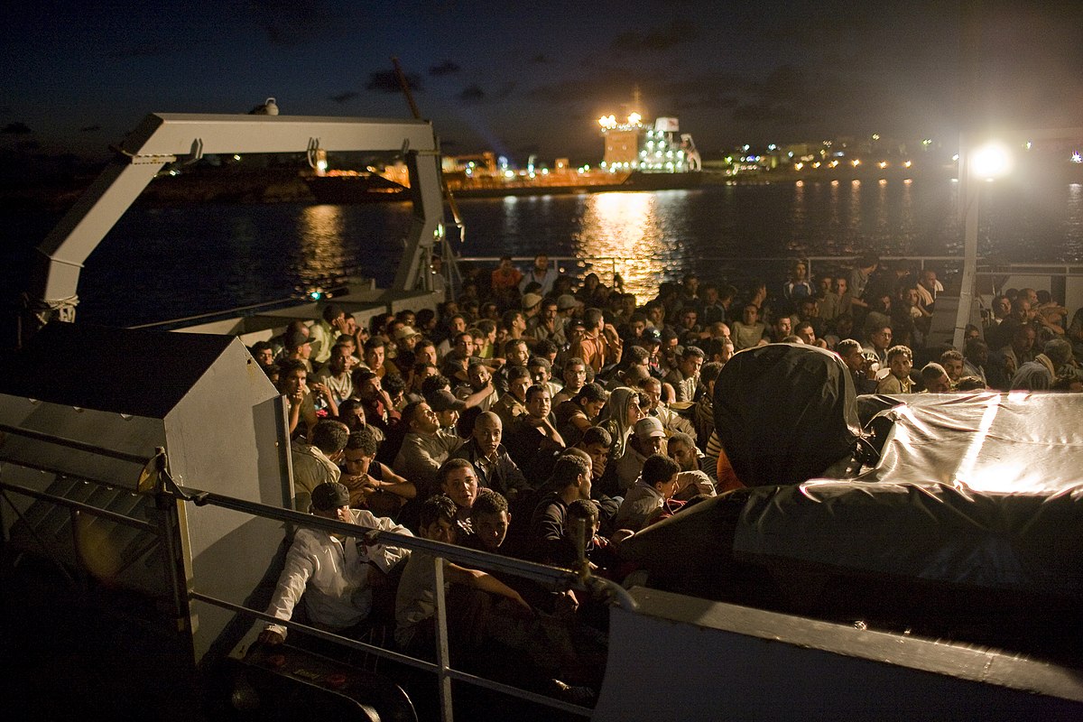 Between January and August, nearly 20,000 people made the perilous overland journey to the coasts of Libya or Tunisia, to cross the Mediterranean and land on Italy's southernmost territory, the islet of Lampedusa. Many have already spent weeks, months and even years on the road and once on the coast, must entrust what little money they have left to the local criminal syndicates that traffic in human beings, and smaller and ever more dangerous boats..On land, after triage by the Medecins Sans Frontieres crew, the new arrivals are quickly loaded onto buses and ferried to the reception centre rebuilt a year ago with European Union subsidies, where  migrants are given clean clothes, shoes and a telephone card. They are photographed, identified (if possible) and after a few days' rest, are sent, by air, ferry or hydrofoil to one of Italy's mainland centres, where they await the process of applications for papers and asylum.