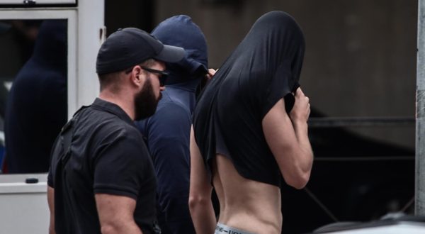 13.08.2023., Atena, Grcka - Poslejdnja skupina privedenih navijaca izlazi pred skudskog istrazitelja izjasniti se o optzbama koje im se stavljau na teret. Inace, svi do sada navijacima koji su izvedeni pred istrazitelja produzen je pritvor. Photo: KOSTAS TZOUMAS/EUROKINISSI/PIXSELL