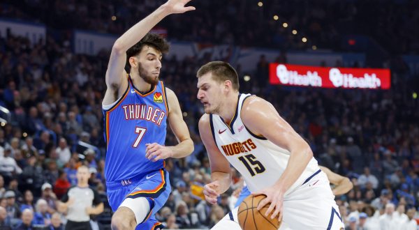 Denver Nuggets center Nikola Jokic (15) drives against Oklahoma City Thunder forward Chet Holmgren (7) in the first half of an NBA basketball game, Sunday, Oct. 29, 2023, in Oklahoma City. (AP Photo/Nate Billings)