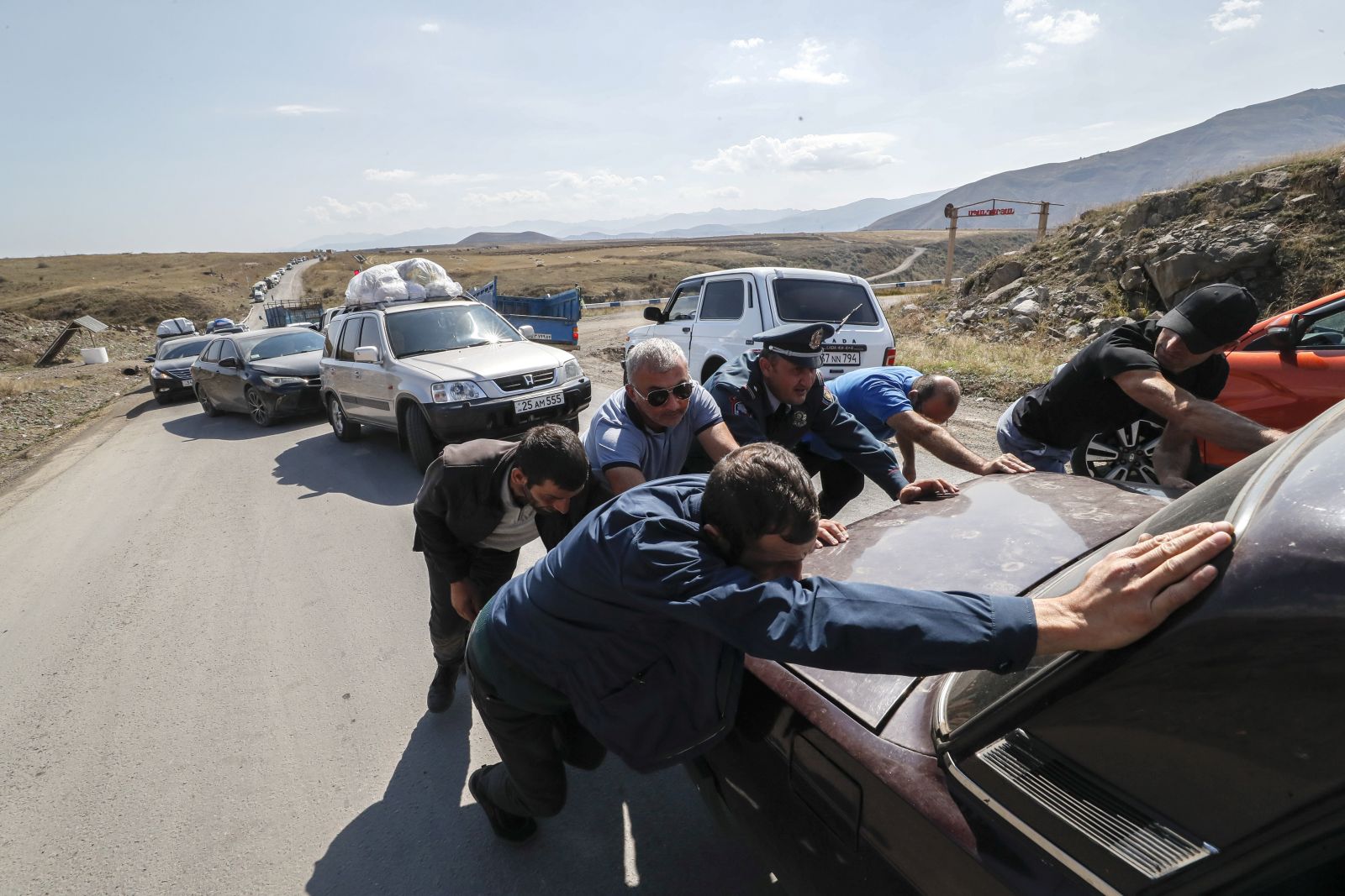 epa10893788 (FILE) - People help to move a broken car as ethnic Armenians fleeing Nagorno-Karabakh region make their way near the village of Kornidzor, Armenia, 28 September 2023. (Issued 01 October 2023). The self-declared Republic of Nagorno-Karabakh, is a territory mostly home to ethnic Armenians that the Soviets allocated to Azerbaijan in 1921 and is recognized as Azerbaijani by the international community.  Some 120,000 ethnic Armenians of the enclave have, in September 2023, joined again the roads to exodus. Caught in the conflict  with Azerbaijan,  and after dozens of violence flares since the 1990's, they have repeatedly had to leave their lands and become displaced or refugees in the tens of thousands, losing over the years their homes and thousands of loved ones to direct fighting or to collateral damage.  After a ceasefire was agreed on, on 20 September 2023, Azerbaijan opened all the checkpoints with Armenia for the unimpeded exit of civilians from the disputed territory. The Armenian government announced the evacuation of more than 96,000 local residents from Nagorno-Karabakh, and a humanitarian center has been set up near the main route between Armenia and the breakaway region. Nagorno-Karabakh will cease to exist as a self-proclaimed state from 01 January 2024, the region's separatist leader, Samvel Shakhramanyan, announced on 28 September, after signing a decree to dissolve all its institutions.  EPA/ANATOLY MALTSEV  ATTENTION: This Image is part of a PHOTO SET