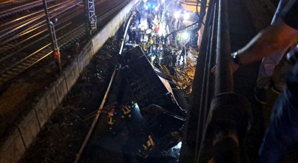 epa10898206 Rescue personnel works at the illuminated site where a bus with passengers on board fell from an elevated section in Mestre, near Venice, to crash down and land on the railway tracks that run alongside the road, in Mestre, Italy, late 03 October 2023. At least two fatalities have been confirmed so far although it is feared that the number of casualties is destined to rise. About forty other persons were reported to have suffered injuries.  EPA/ANDREA BUOSO
