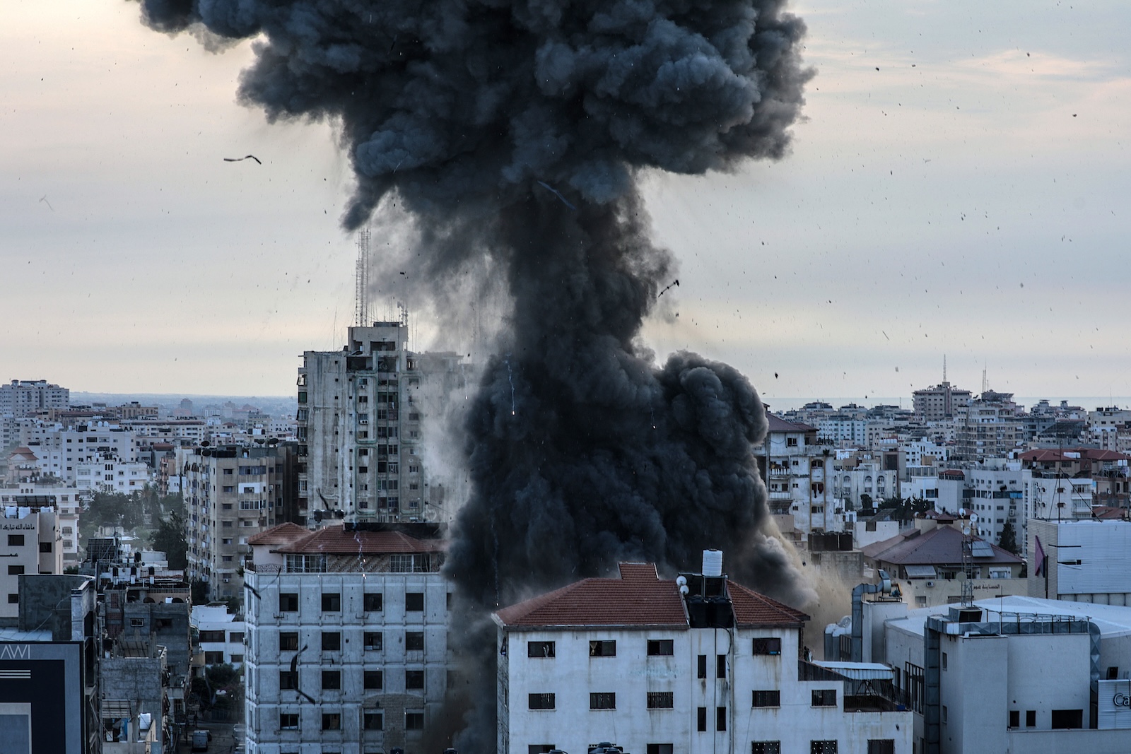 epa10908408 Smoke rises from National Bank building after an Israeli air strike in Gaza City, 08 October 2023. Israeli air strikes, in retaliation for the 07 October Hamas attacks on Israel, have killed 413 people in the Gaza Strip, with almost 2,300 wounded, according to Palestinian Health Ministry. The attacks on Israel killed more than 700 Israelis and left over 2,240 injured, the Israeli army said 08 October.  EPA/MOHAMMED SABER