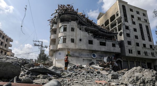 epa10911225 Palestinians inspect a destroyed building of the Palestine Telecommunications Company (Paltel) following Israeli air strikes at the Al-Ramal neighborhood in Gaza City, 10 October 2023. More than 700 people have been killed and around 4,000 have been injured according to the Palestinian Ministry of Health, after Israel started bombing the Palestinian enclave in response to an attack carried out by the Islamist movement Hamas on 07 October. More than 3,000 people, including 1,500 militants from Hamas, have been killed and thousands injured in Gaza and Israel since 07 October, according to Israeli military sources and Palestinian officials.  EPA/MOHAMMED SABER