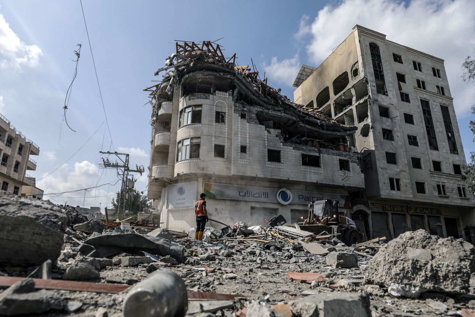 epa10911225 Palestinians inspect a destroyed building of the Palestine Telecommunications Company (Paltel) following Israeli air strikes at the Al-Ramal neighborhood in Gaza City, 10 October 2023. More than 700 people have been killed and around 4,000 have been injured according to the Palestinian Ministry of Health, after Israel started bombing the Palestinian enclave in response to an attack carried out by the Islamist movement Hamas on 07 October. More than 3,000 people, including 1,500 militants from Hamas, have been killed and thousands injured in Gaza and Israel since 07 October, according to Israeli military sources and Palestinian officials.  EPA/MOHAMMED SABER