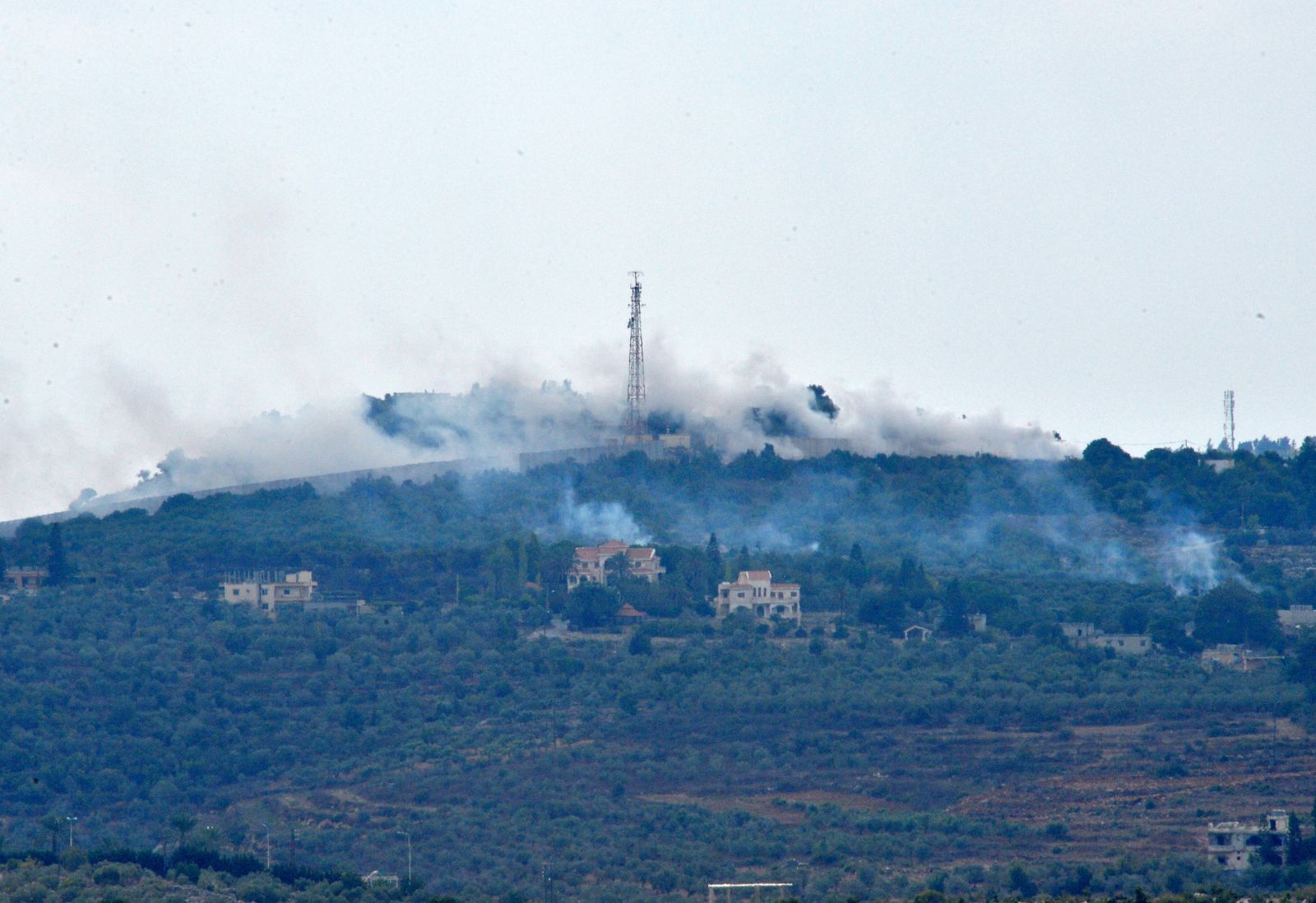 epa10913224 Smoke rises from positions on a hill after Israeli shelling on the outskirts of Dhayra village, near the Lebanese-Israeli border, Lebanon, 11 October 2023. Hezbollah said on 11 October it fired missiles on Israel, two days after three of its members were killed in border towns. The Israel Defence Forces (IDF) said an anti-tank missile was launched from Lebanon toward a military post adjacent to the community of Arab Al-Aramshe on the BlueLine, and it responded by shelling Southern Lebanese towns.  EPA/WAEL HAMZEH