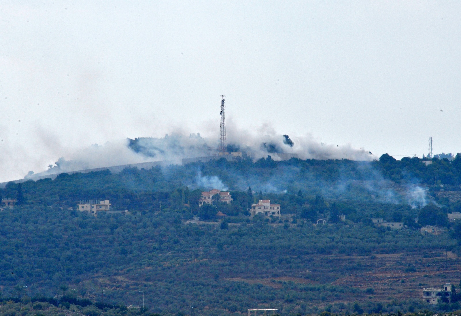epa10913224 Smoke rises from positions on a hill after Israeli shelling on the outskirts of Dhayra village, near the Lebanese-Israeli border, Lebanon, 11 October 2023. Hezbollah said on 11 October it fired missiles on Israel, two days after three of its members were killed in border towns. The Israel Defence Forces (IDF) said an anti-tank missile was launched from Lebanon toward a military post adjacent to the community of Arab Al-Aramshe on the BlueLine, and it responded by shelling Southern Lebanese towns.  EPA/WAEL HAMZEH