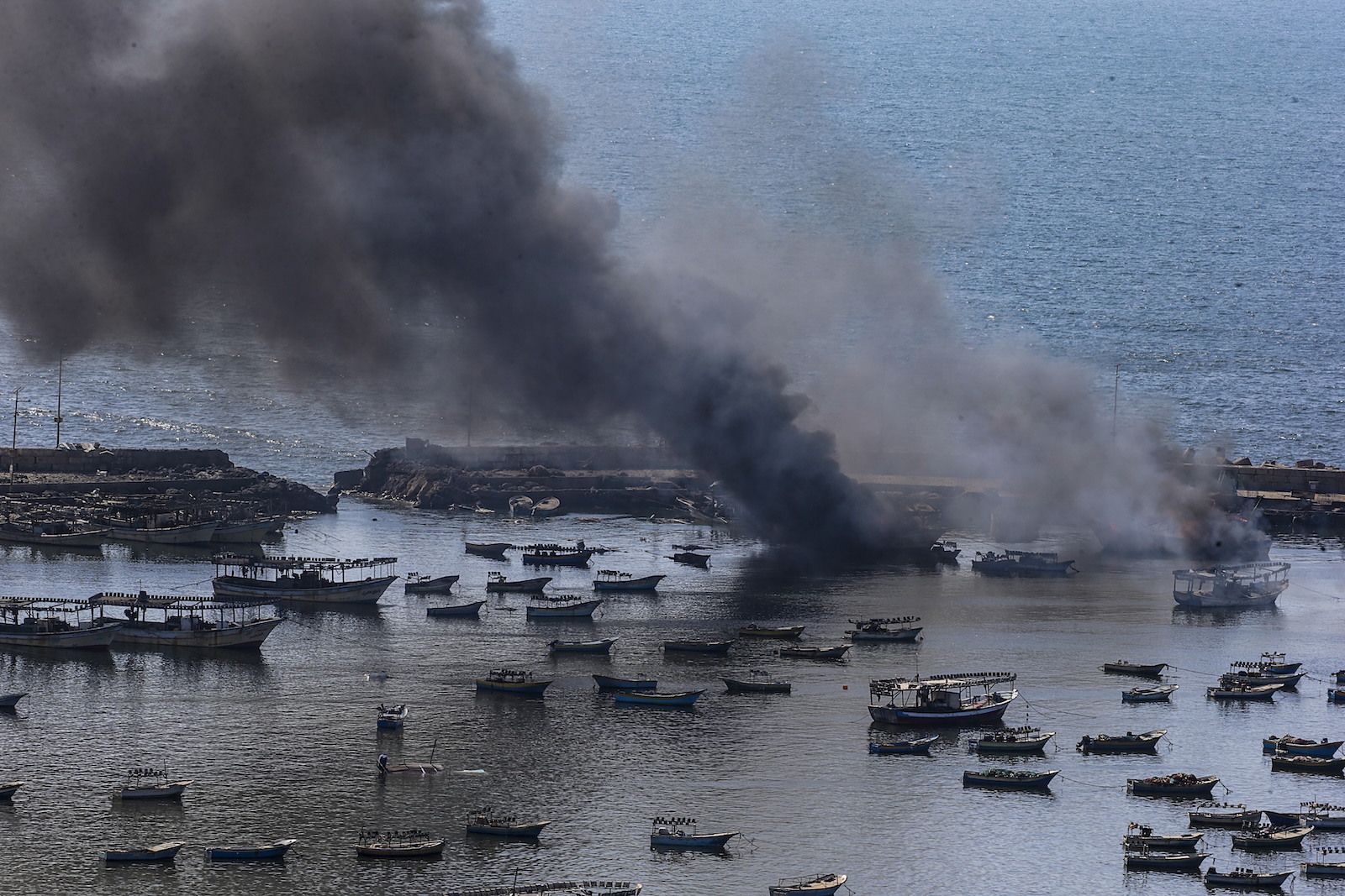 epa10915010 Smoke rises from the Gaza port following an Israeli air strike, in Gaza City, 12 October 2023. More than 1,400 Palestinians have been killed and over 6,000 others injured, according to the Palestinian Ministry of Health, after Israel started bombing the Palestinian enclave in response to attacks carried out by the Islamist movement Hamas on Israel from the Gaza Strip on 07 October. More than 4,000 people, including 1,500 militants from Hamas, have been killed and thousands injured in Gaza and Israel since 07 October, according to Israeli military sources and Palestinian officials.  EPA/MOHAMMED SABER