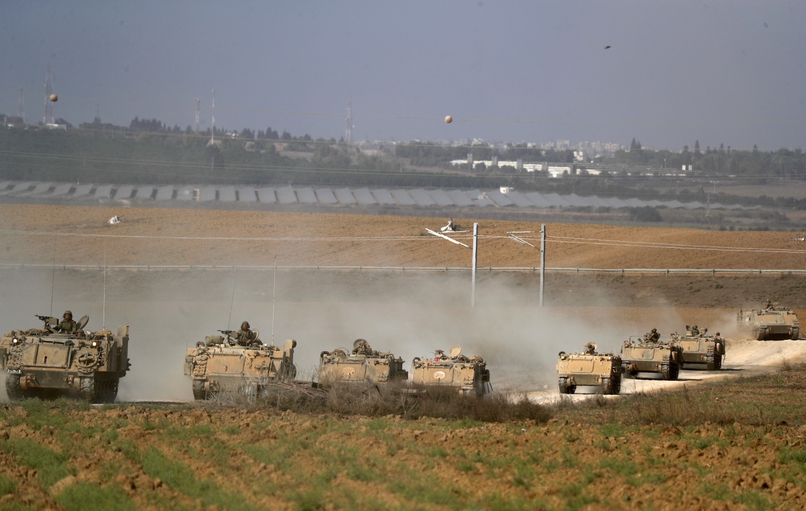 epa10916242 A column of heavy armoured personnel carriers (APCs) at an area along the border with Gaza, southern Israel, 13 October 2023. The Israel Defense Forces (IDF) on 13 October called for the evacuation of all civilians of Gaza City from their homes southwards 'for their own safety and protection' and to move south of the Wadi Gaza, warning that in the following days Israeli military operations will take place in the Palestinian city. More than 1,300 Israelis have been killed and over 3,200 others injured, according to the IDF, after the Islamist movement Hamas launched an attack against Israel from the Gaza Strip on 07 October. More than 1,500 Palestinians have been killed and over 6,600 others injured in Gaza since Israel launched retaliatory air strikes, Palestinian health officials said.  EPA/ATEF SAFADI