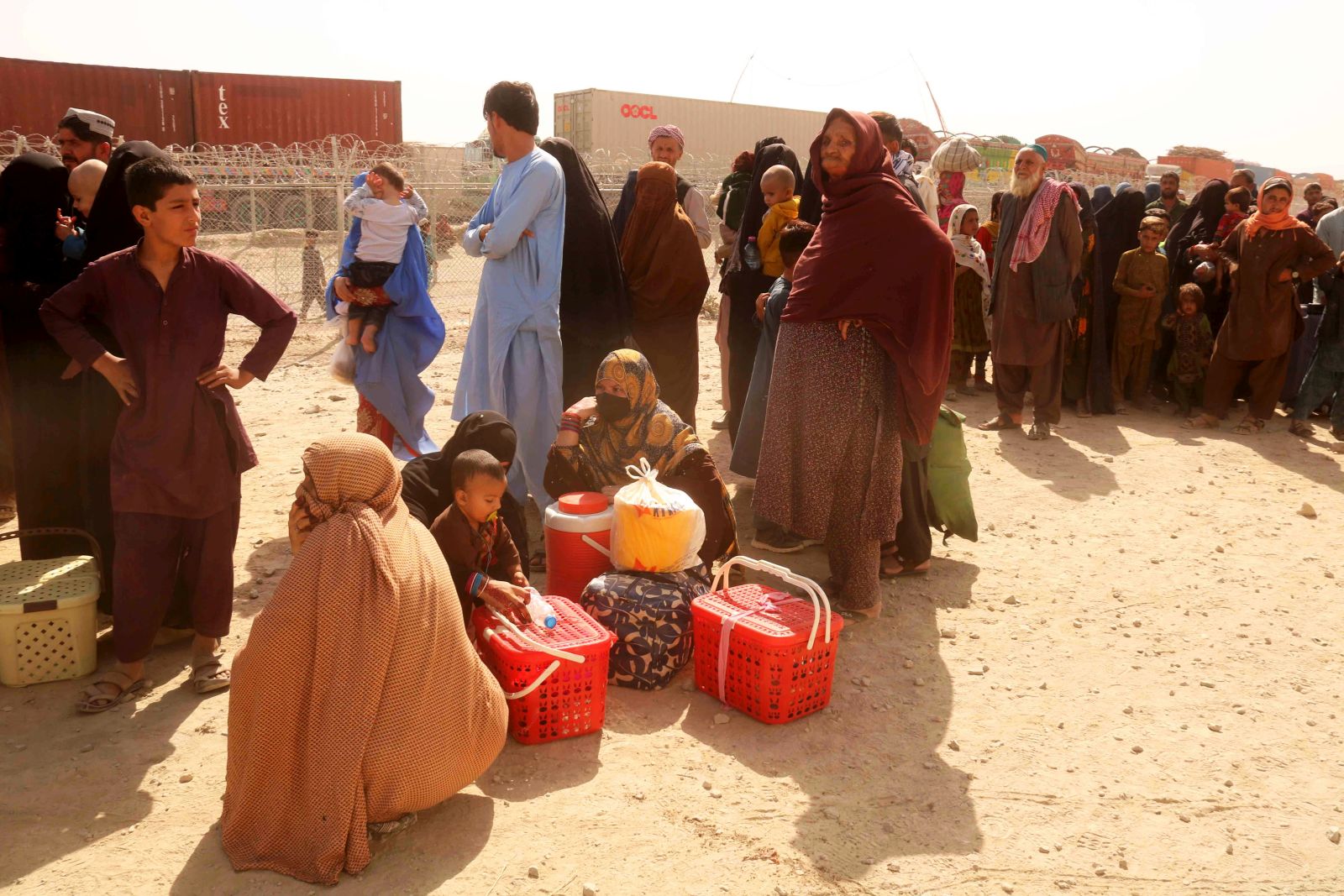 epa10917033 Afghan people wait to board on trucks as they voluntarily depart for their homeland, with the support of the UNHCR, following Pakistan's order for all illegal migrants to leave the country at the Pakistan-Afghanistan border in Chaman, Pakistan, 13 October 2023. Pakistani government ordered all immigrants, including 1.73 million Afghans living illegally, to leave the country by the end of the month or face expulsion after a surge in militant attacks, largely blamed on Afghan militants.  EPA/AKHTER GULFAM