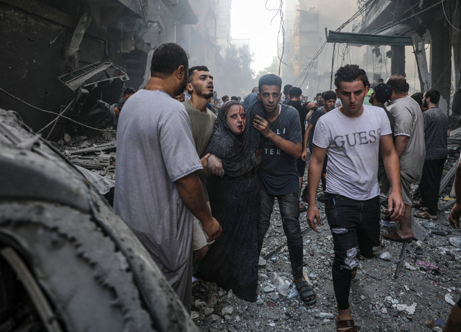 epaselect epa10919048 An injured woman is helped away from the site of an Israeli rocket attack in Al- Shati refugee camp in the west of Gaza City on, 14 October 2023. The Israeli Defense Force (IDF) on 13 October called for the evacuation of all civilians of northern Gaza ahead of an expected ground invasion. More than 1,300 Israelis have been killed and over 3,200 others injured, according to the IDF, after the Islamist movement Hamas launched an attack against Israel from the Gaza Strip on 07 October. More than 2,000 Palestinians have been killed and over 8,700 others injured in Gaza since Israel launched retaliatory air strikes, the Palestinian health ministry said.  EPA/MARTIN DIVISEK  EPA-EFE/MOHAMMED SABER