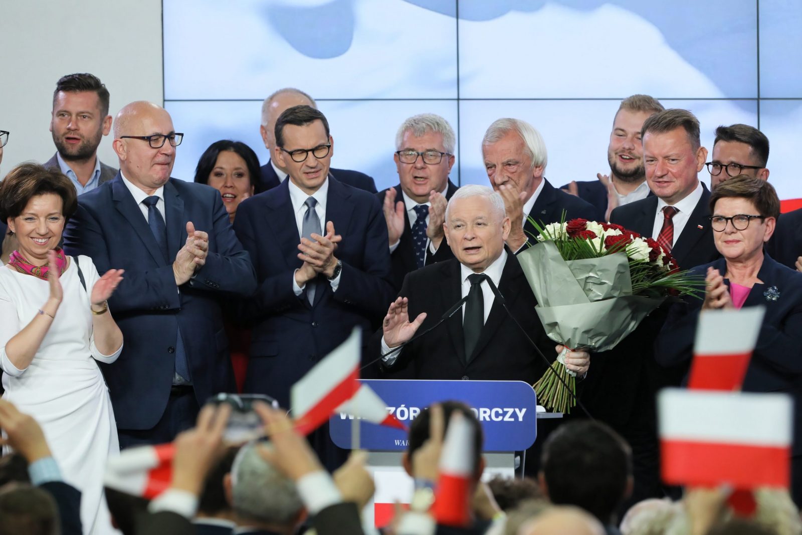 epa10920956 Leader of the Polish Law and Justice (PiS) rulling party Jaroslaw Kaczynski (C) reacts during Law and Justice party parliamentary elections night in Warsaw, Poland, 15 October 2023 in Warsaw, Poland, 15 October 2023. Parliamentary elections are underway in Poland, in which citizens elect 460 MPs and 100 senators for a four-year term. In addition to the elections on the same day, Poland will hold a four-point referendum on the privatization of state-owned enterprises, increasing the retirement age, accepting migrants under the EU relocation mechanism and removing border barriers with Belarus.  EPA/Pawel Supernak POLAND OUT