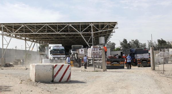 epa10930601 Personnel from the UN and Palestine Red Crescent Society unload trucks carrying humanitarian aid for Gaza Strip after they enter from Egypt in Rafah, 21 October 2023. As Egypt is to host, on 21 October, an international summit about Gaza, and following the negotiations between Egypt, the US, and Israel to allow relief aid to enter the Gaza Strip, some 20 aid trucks carrying food, water, and medicine have been allowed into the Gaza Strip through the Rafah land crossing on 21 October. The move comes after days during which trucks were blocked on the Egyptian side of the Rafah border crossing. Egypt's Foreign Ministry had requested that the Isareli strikes on the area near the Gaza side of the border crossing stop, in order to allow the passage of the aid.  EPA/HAITHAM IMAD