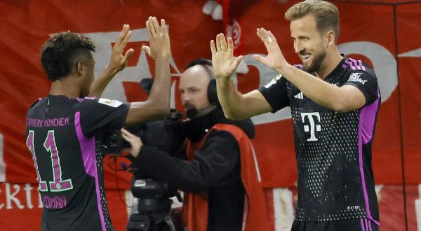 epa10931108 Munich's Harry Kane (R) celebrates with Kingsley Coman after scoring the 2-0 lead during the German Bundesliga soccer match between 1. FSV Mainz 05 and FC Bayern Munich in Mainz, Germany, 21 October 2023.  EPA/RONALD WITTEK CONDITIONS - ATTENTION: The DFL regulations prohibit any use of photographs as image sequences and/or quasi-video.