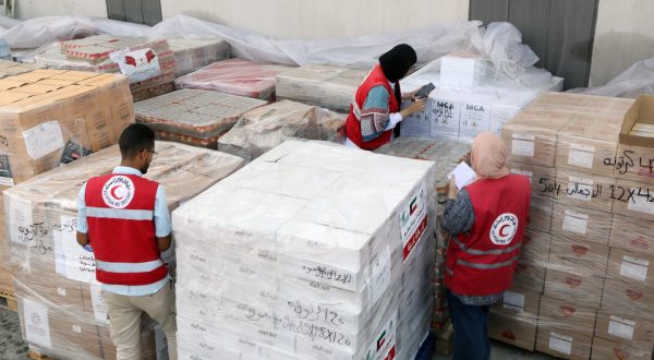 epa10944749 Egyptian Red Crescent Society employees handle humanitarian aid bound for Palestinians in the Gaza Strip, at a warehouse in Arish, Egypt, 28 October 2023. More than 7,000 Palestinians and at least 1,300 Israelis have been killed, according to the Israel Defense Forces (IDF) and the Palestinian health authority, since Hamas militants launched an attack against Israel from the Gaza Strip on 07 October, and the Israeli operations in Gaza and the West Bank which followed it.  EPA/KHALED ELFIQI