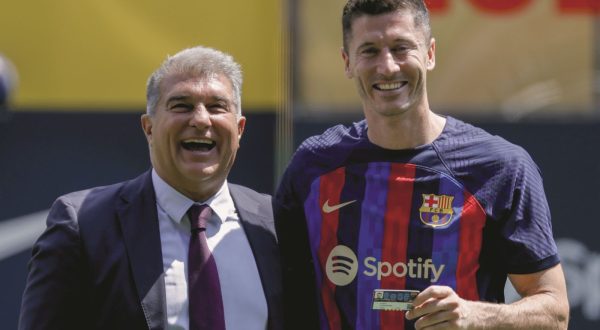 Polish forward Robert Lewandowski, right, and FC Barcelona president Joan Laporta react, during the official presentation after signing for FC Barcelona, in Barcelona, Spain, Friday, Aug. 5, 2022. (AP Photo/Joan Monfort)