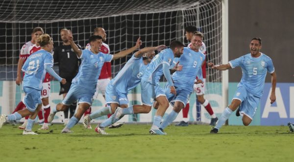San Marino's Alessandro Golinucci, fourth from right, celebrates with his teammates after scoring his side's opening goal during the Euro 2024 group H qualifying soccer match between San Marino and Denmark at the San Marino Stadium in Serravalle, San Marino, Tuesday, Oct. 17, 2023. (AP Photo/Felice Calabro)