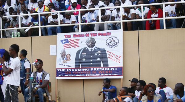 epa06404394 Campaign poster of  George Weah, presidential candidate  the opposition  Coalition for  Democratic Change (CDC),  cheers during closing   of campaigns  at the Samuel Kanyon Doe Sports Complex in Monrovia,  Liberia, 23 December 2017. Liberians go to the polls on 26 December, in  run-off presidential elections to choose between George Weah, presidential candidate of the Coalition for Democratic Change (CDC), and Joseph Nyuma Boakai, presidential candidate and incumbent vice president, representing the governing Unity party (UP) to succeed Ellen Johnson Sirleaf, who  concludes her second and final term of office.  EPA/AHMED JALLANZO