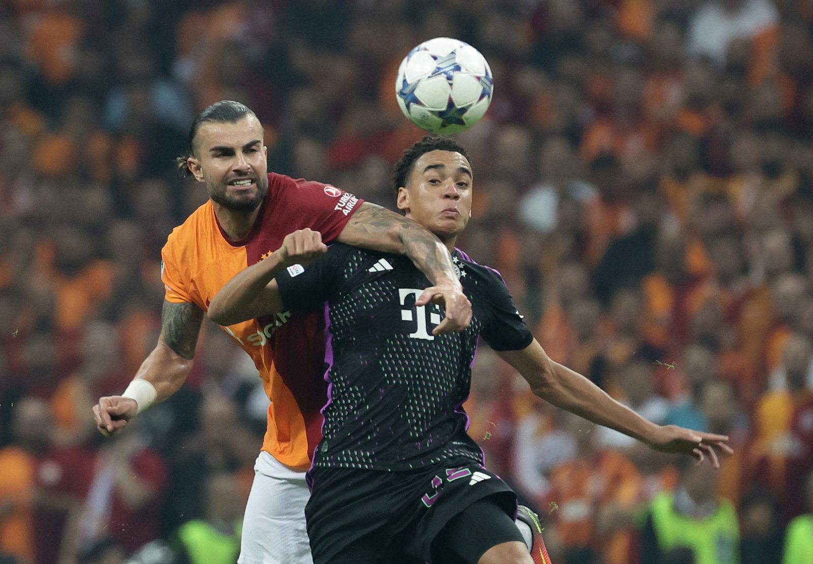 epa10936766 Abdulkerim Bardakci (L) of Galatasaray in action against Jamal Musiala (R) of Bayern Munich during the UEFA Champions League Group A soccer match between Galatasray SK and FC Bayern Munich in Istanbul, Turkey, 24 October 2023.  EPA/ERDEM SAHIN